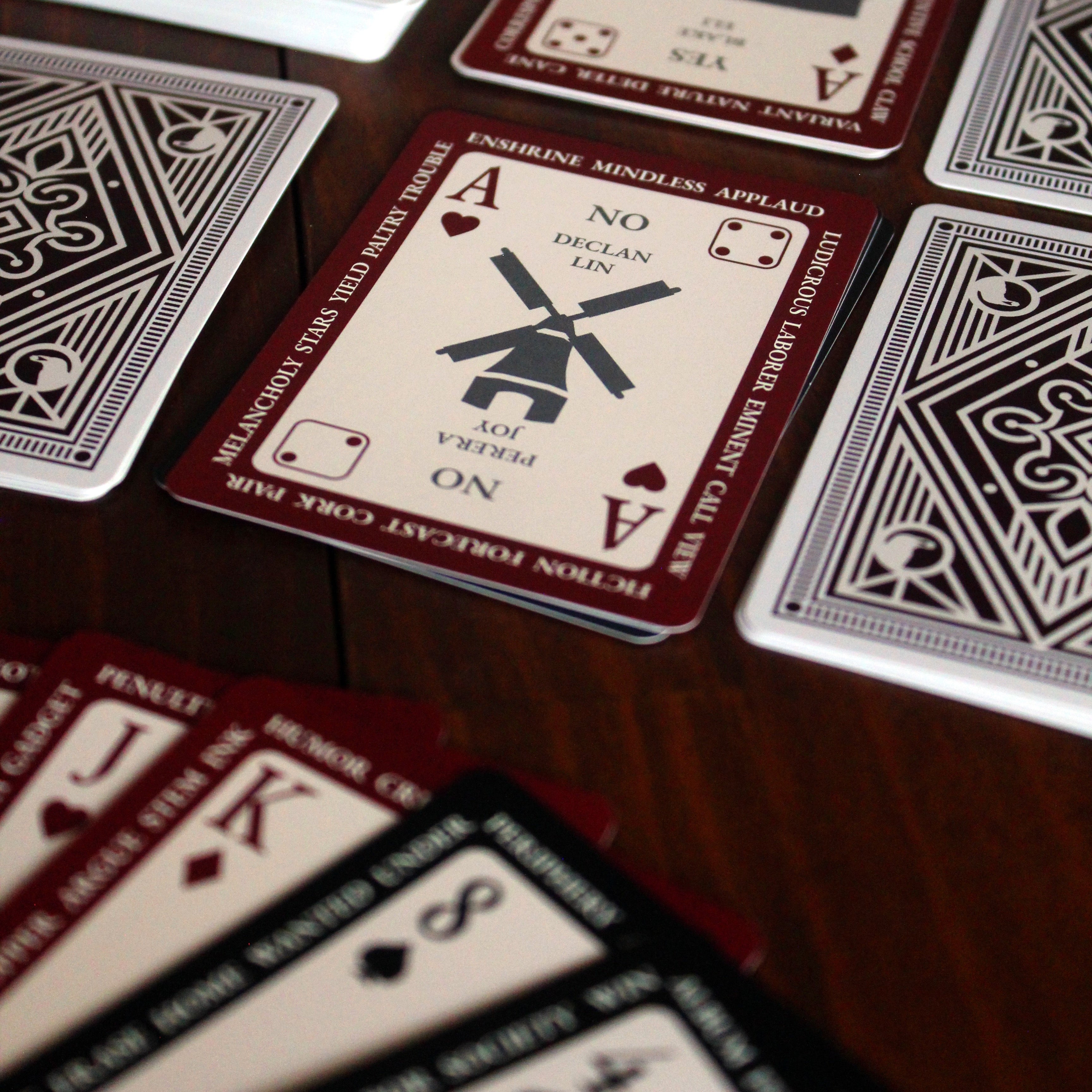 Playing cards with unique designs on a wooden surface