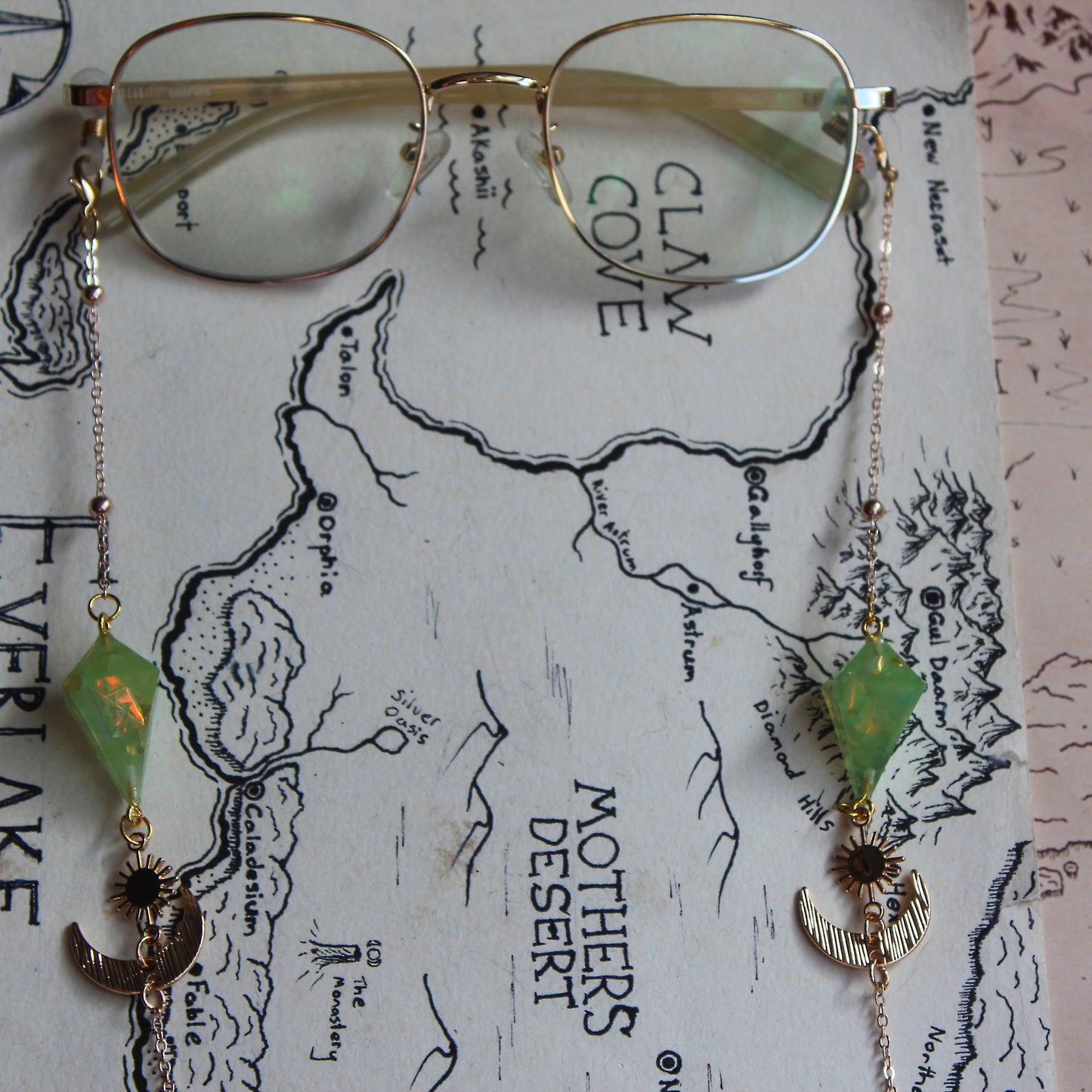 Green Planet with a Sun and Moon Glasses Chain with Dice
