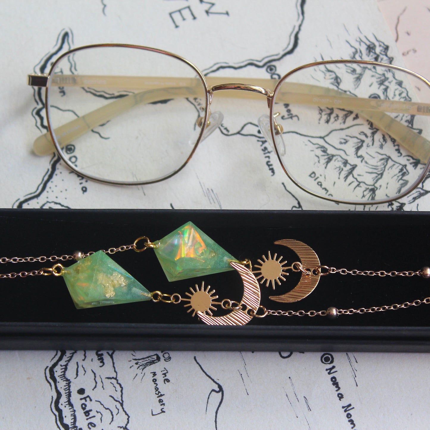 Green Planet with a Sun and Moon Glasses Chain with Dice