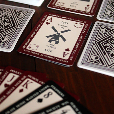Playing cards with unique designs on a wooden surface